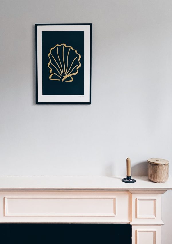 gold foil shell print above fireplace